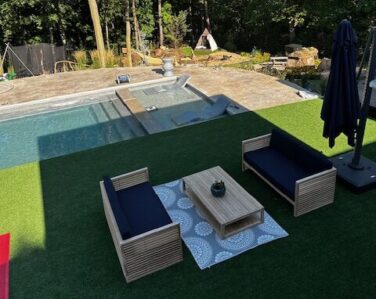 Minimalistic outdoor oasis with pool, patio, sitting area, firepit and water features.